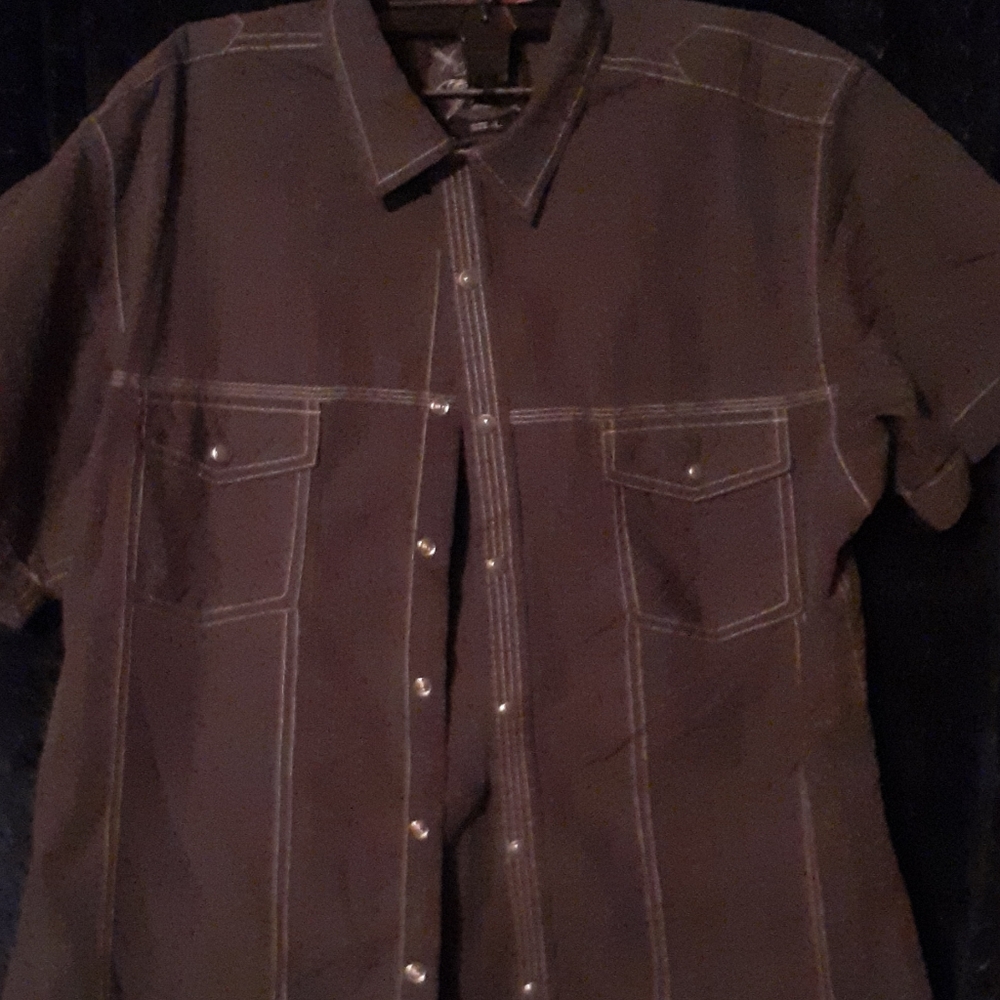 Gray button down shirt with gray buttons.